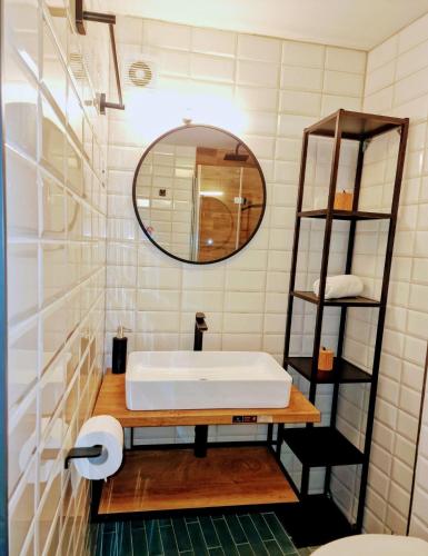 a bathroom with a white sink and a mirror at Lassini in Mali Lošinj