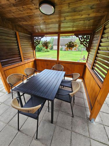 a porch with a table and chairs in a house at Kwatera27 in Kleszczele