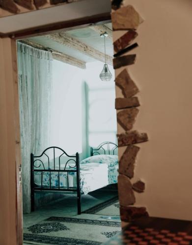 a mirror in a room with a bed and a window at BenSon Adventures Resort in Gomkʼ
