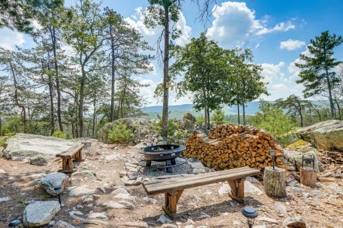 a fire pit with a pile of fire wood at Secluded Mountain Cabin in Wardensville! in Wardensville