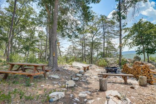 a picnic table and a grill in the woods at Secluded Mountain Cabin in Wardensville! in Wardensville