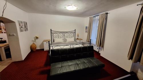 a living room with a black couch and a window at Leipa Apart in Česká Lípa