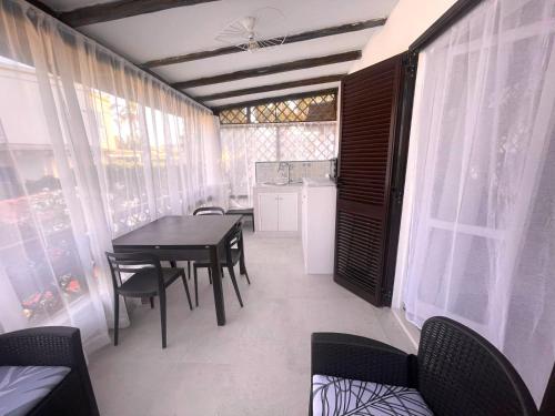 a dining room with a table and chairs and a kitchen at Kyria Luxury Apartment in Vulcano