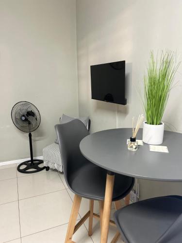 a dining room with a table and a fan at Meridian Suite Apartments in Umhlanga Ridge in Durban