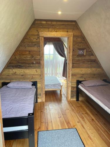 a room with two bunk beds in a cabin at Auci Guest house 1 in Liepāja