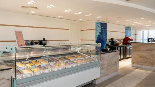 a bakery with a display case filled with pastries at Cleopatra Sidi Heneish in Marsa Matruh