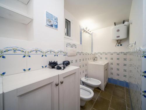 a white bathroom with a toilet and a sink at LA FINESTRA SUL MARE - Antonella Apartment in Vieste