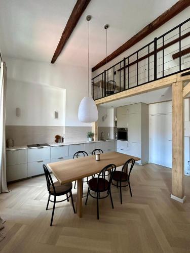 une cuisine et une salle à manger avec une table et des chaises en bois dans l'établissement Luxury Loft in Central Marseille, à Marseille
