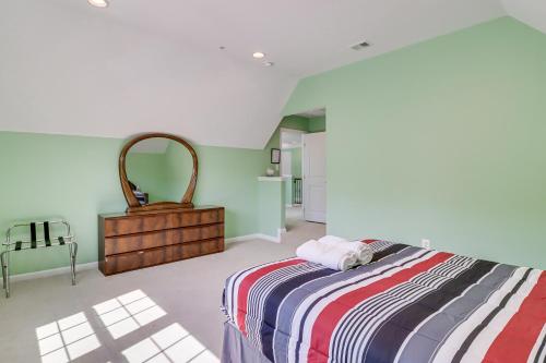 a bedroom with a bed and a dresser and a mirror at Spacious Accokeek Home Near MGM, Alexandria and DC! in Accokeek