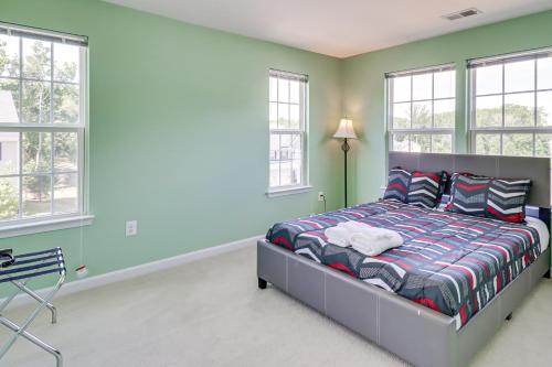 a bedroom with a bed in a room with windows at Spacious Accokeek Home Near MGM, Alexandria and DC! in Accokeek