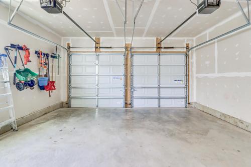 a garage with two garage doors in a room at Spacious Accokeek Home Near MGM, Alexandria and DC! in Accokeek