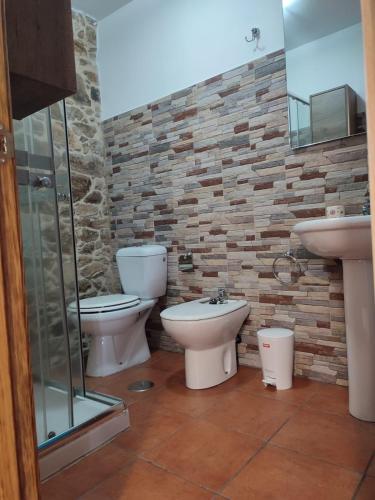 a bathroom with two toilets and a sink at Casa Floriña in Outes