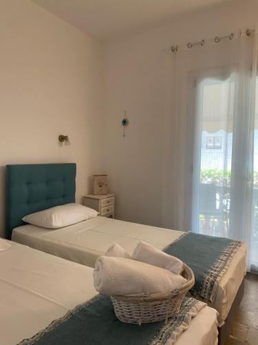 a bedroom with two beds and a wicker basket at Marili Apartments in Roda