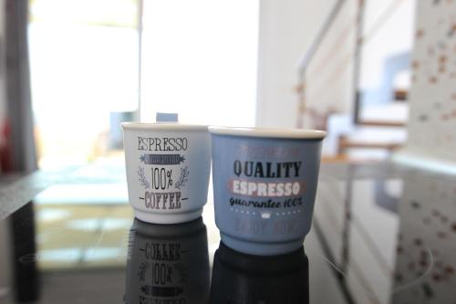 two cups sitting on top of a glass table at LOUTRA VILLAS in Agia Paraskevi