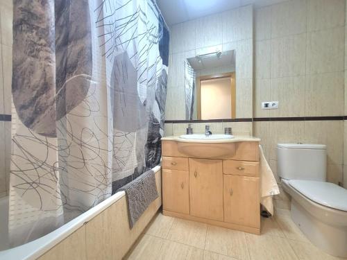 a bathroom with a sink and a shower curtain at Urbanización Panorámica Golf in Sant Jordi