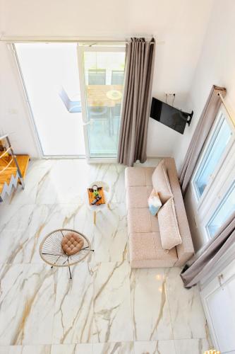 a living room with a marble floor at LOUTRA VILLAS in Agia Paraskevi