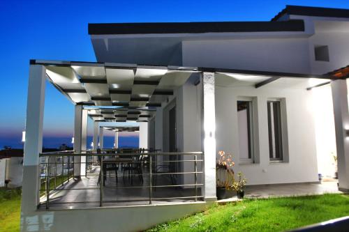 a balcony of a house with a table at LOUTRA VILLAS in Agia Paraskevi