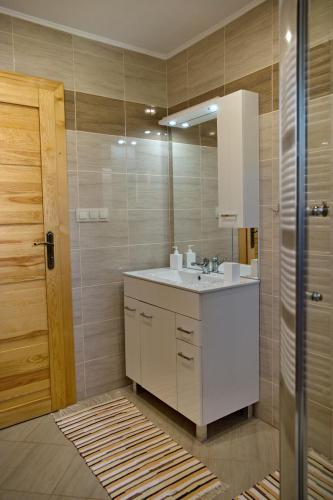 a bathroom with a sink and a mirror at Vila Belianka in Ždiar