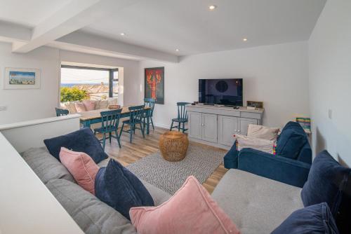 a living room with a couch and a dining room at Jumble Cottage in Seaview