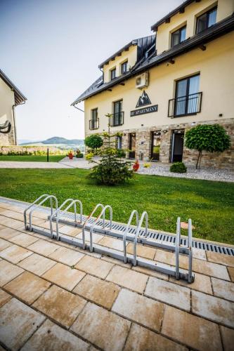a metal bench in front of a building at HP APARTMÁNY SKIAREÁL- Buková Hora v Orlických horách 100 m od lanovky in Červená Voda