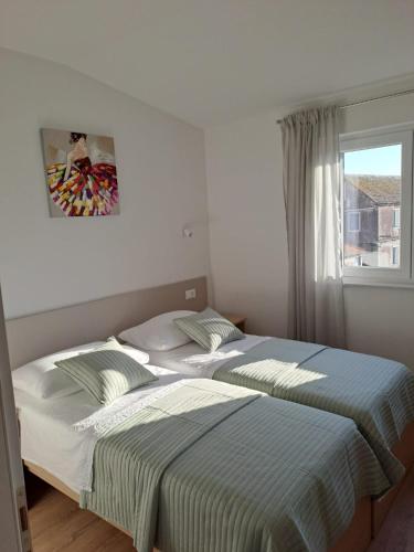 two beds sitting next to each other in a bedroom at Smokvica - NEW in Primošten