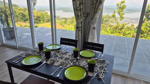 a table with green plates on it with a view at Wonogiri Rocks in Tempuran