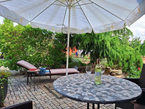 a table with an umbrella on a patio at Appartements Regina in Mörbisch am See