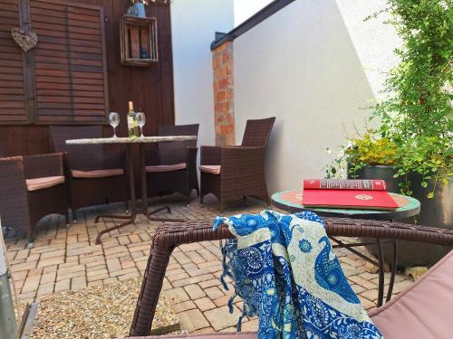 a patio with a table and chairs and a table and a blanket at Appartements Regina in Mörbisch am See
