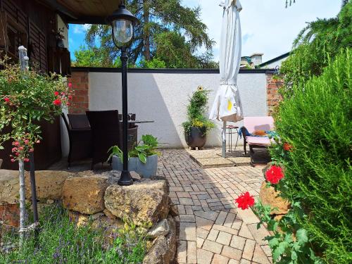 a patio with a light pole and some plants at Appartements Regina in Mörbisch am See