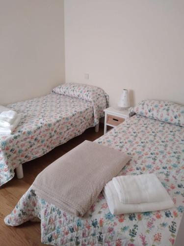 a room with two beds and a pillow on the floor at Mirador de Barreiros in Barreiros