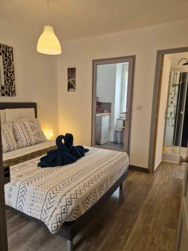 a bedroom with a bed with a robe on it at 17, face à la gare in Lannion