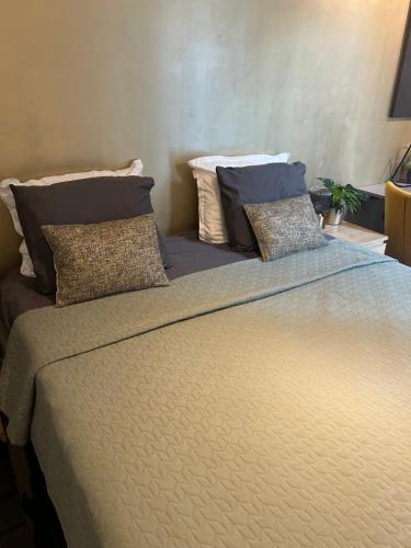 a large bed with two pillows on top of it at B&B Noordoostpolder in Emmeloord