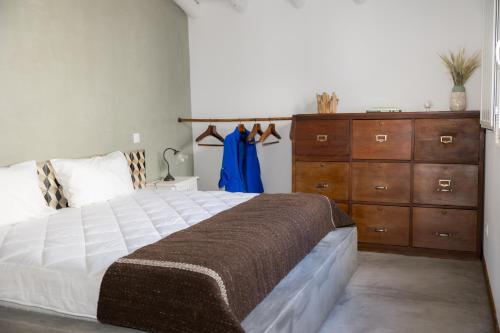a bedroom with a large bed and a dresser at Casas Velhas - Casa da Taberna in Castro Verde