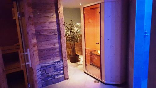 a hallway with a mirror and a room with a plant at Hotel Europa in Saas-Fee