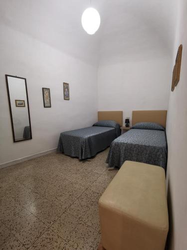 a room with two beds and a mirror at Appartamento San Michele in Volterra