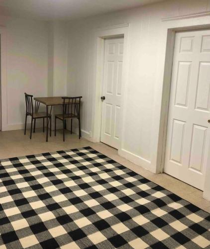 a room with a table and chairs and a door at Private 2-bedroom apartment with direct bus to NYC Manhattan only a 5-minute walk away in Elizabeth