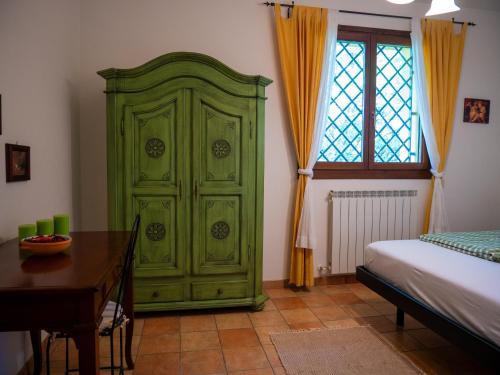 a green cabinet in a room with a table at Agri Borgata Vallone - Apartments - by HOST4U in Lecchiore