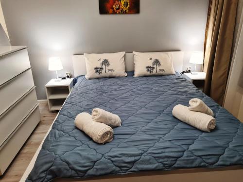 a bedroom with a large bed with towels on it at Sunrise Luxury Sauth Bay in Varna City