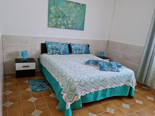 a bedroom with a bed with blue pillows at Villa Lilium in Bari