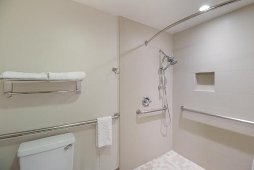 a bathroom with a shower and a toilet at Best Western Woodland Hills in Woodland Hills