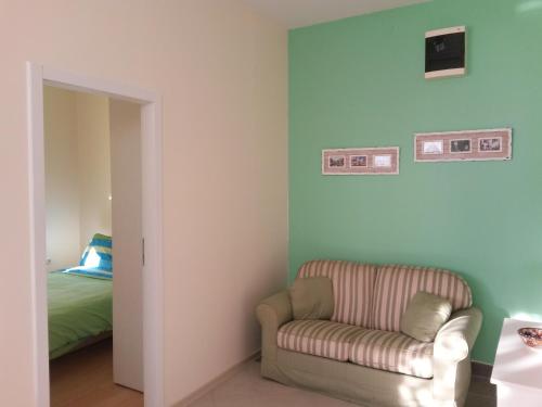 a living room with a chair and a bed at Apartment Katarina in Banja Koviljača