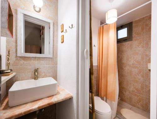 a bathroom with a sink and a toilet at Οdyssey Apartments Lefkas Centrum in Lefkada