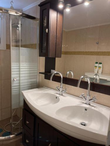 a bathroom with a sink and a shower at Karras House in Kimolos