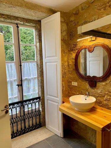 a bathroom with a sink and a mirror at Hotel Pazo de Bieite in Boimorto