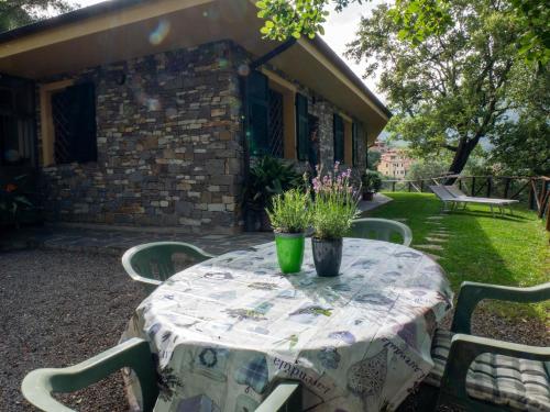 a table with chairs and flowers on a patio at Agri Borgata Vallone - Apartments - by HOST4U in Lecchiore
