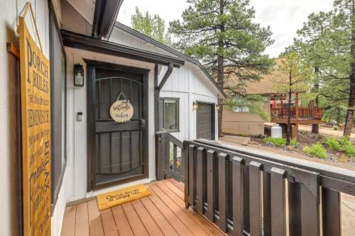 a porch with a black door on a house at Wraparound Deck and Poker Room Cabin in Munds Park in Munds Park