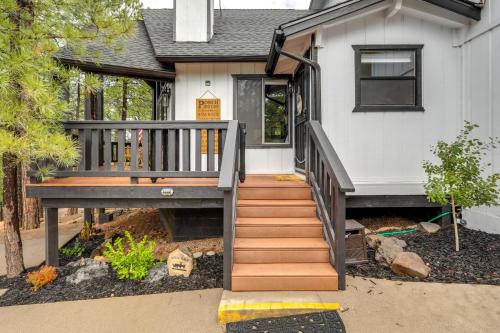 a home with a wooden staircase leading to the front door at Wraparound Deck and Poker Room Cabin in Munds Park in Munds Park