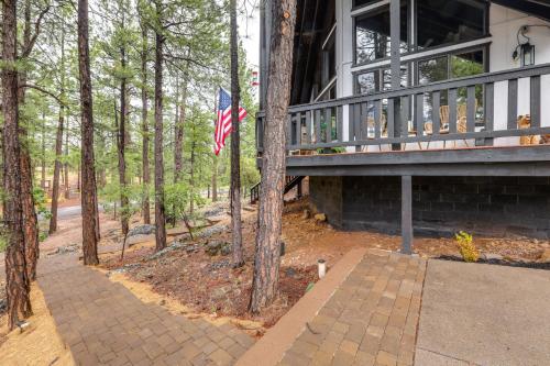 a house with an american flag on the porch at Wraparound Deck and Poker Room Cabin in Munds Park in Munds Park