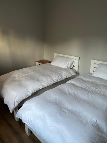 two beds sitting next to each other in a bedroom at Killyfole lakeside lodges in Corranny