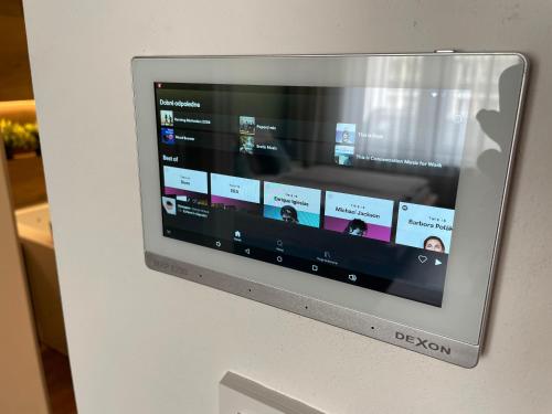 a television screen with a website on a wall at Golden Key Apartments in Liberec